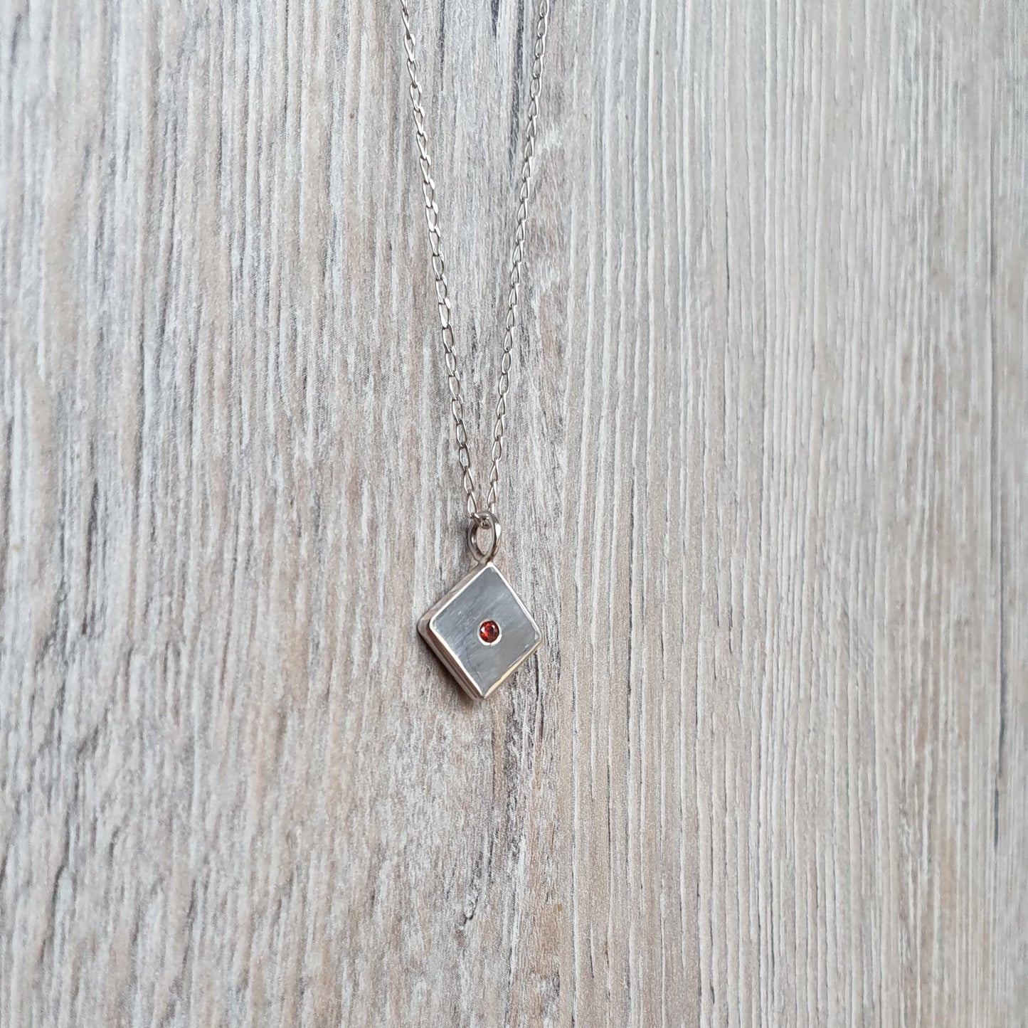 Square pendant with Red Cubic Zirconia flush set stone