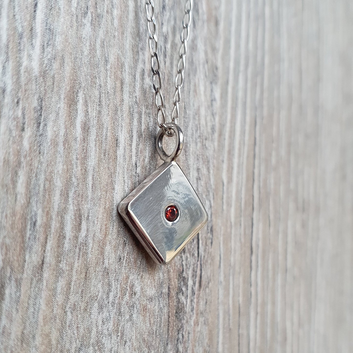 Square pendant with Red Cubic Zirconia flush set stone