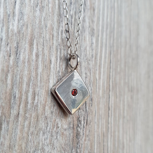 Square pendant with Red Cubic Zirconia flush set stone