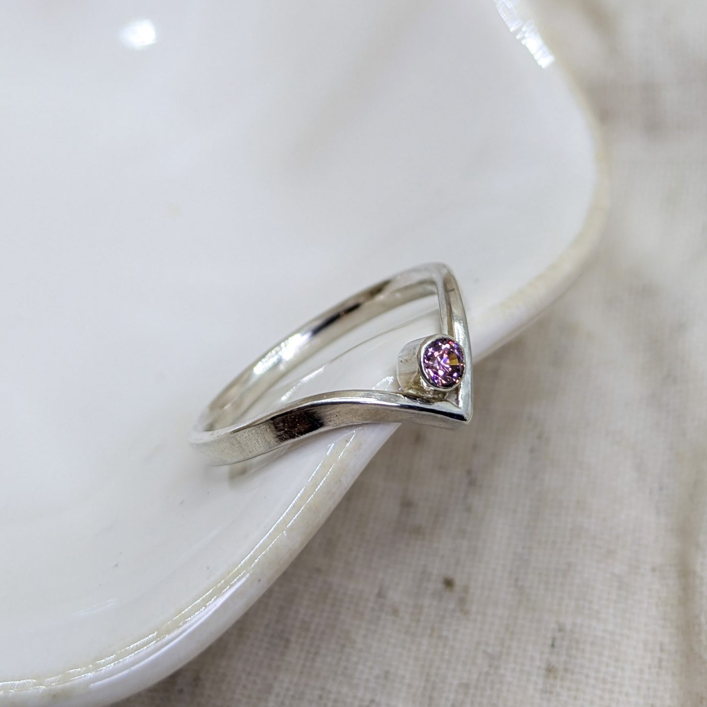 Sterling silver wishbone ring with a 3mm tube set pink Cubic Zirconia