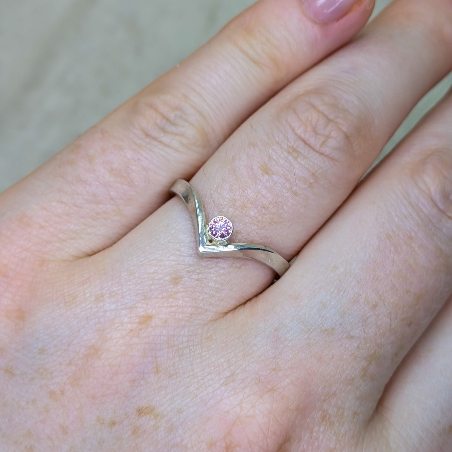 Sterling silver wishbone ring with a 3mm tube set pink Cubic Zirconia