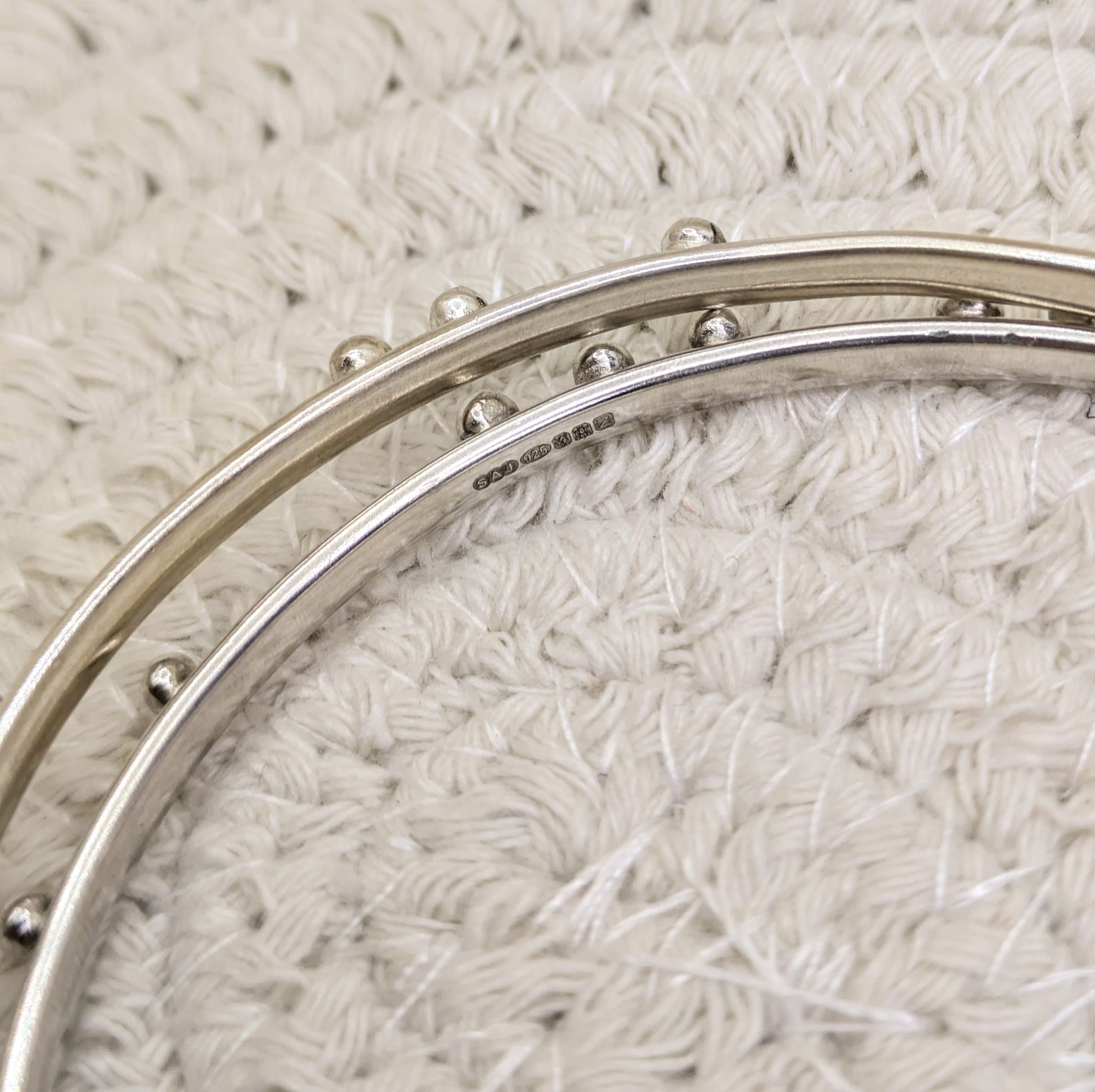 Two bangles from the hidden messages collection showing the hallmark 